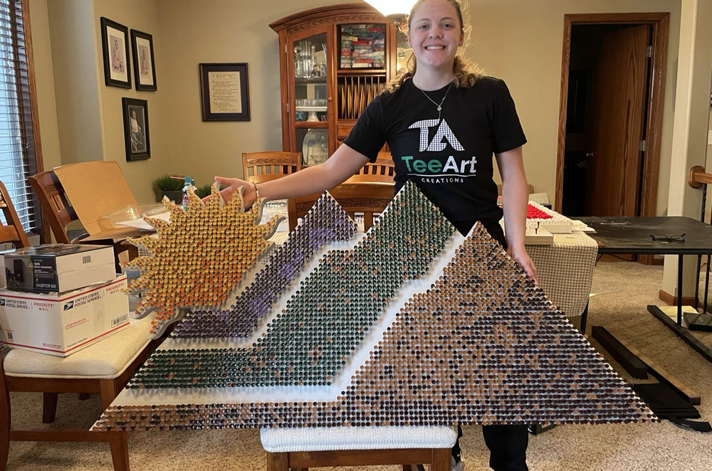 PGA West, a nine-course resort in La Quinta, California. For them, she created a five-foot course logo using 3,775 golf tees.
