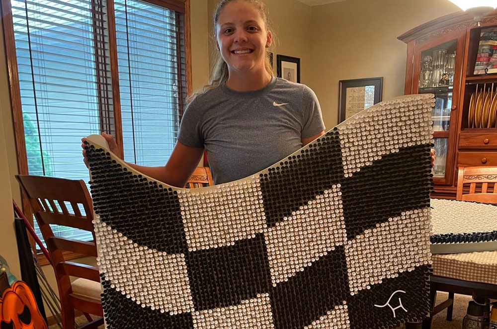 Sand Hills Golf Club in Mullen, Nebraska, a top 10 golf course in the world, for which she erected a replica course flag using 4,872 golf tees.