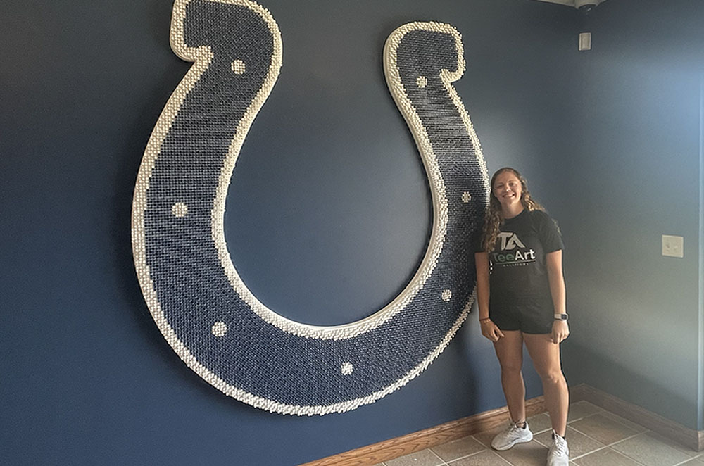 The Indianapolis Colts, in which she created a seven-foot-tall logo using 11,156 blue and white golf tees set at three different heights.